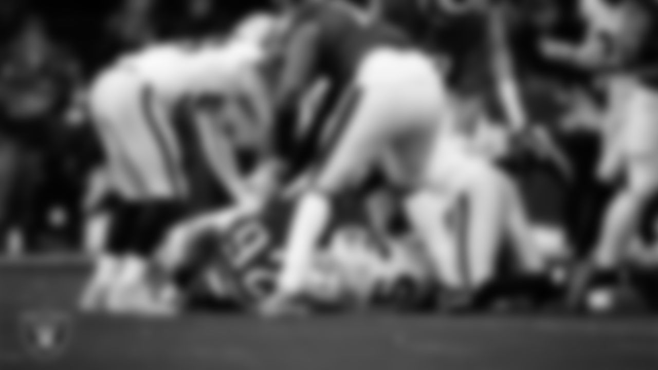 Las Vegas Raiders defensive tackle Adam Butler (69) and linebacker Devin White (45) make a tackle during the regular season away game against the Philadelphia Eagles at Lincoln Financial Field.