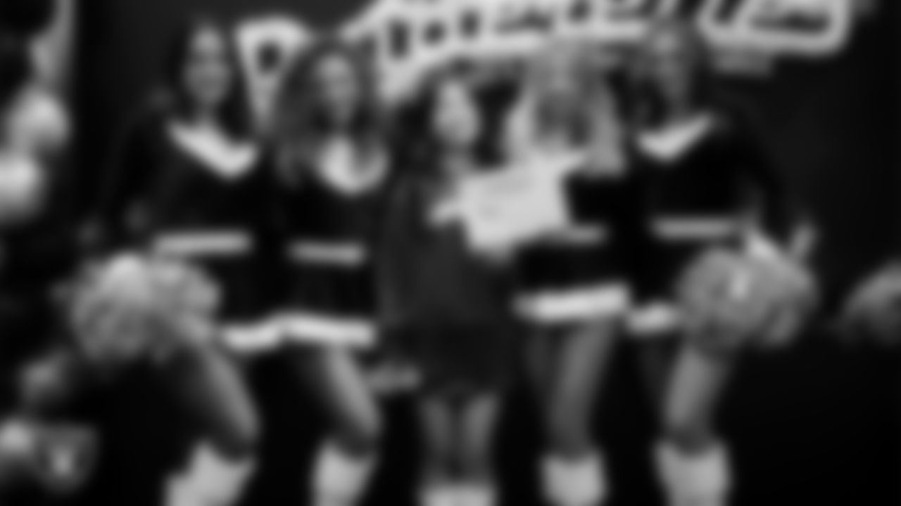 Raiderettes pose for a photo with a Junior Raiderette during the Junior Raiderettes Banquet at The Studio.