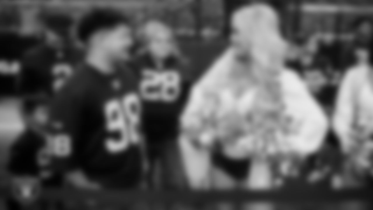 Marcos Carrillo from Make-A-Wish talks with Raiderette Pip on the sidelines before the Las Vegas Raiders' regular season home game against the Jacksonville Jaguars at Allegiant Stadium.