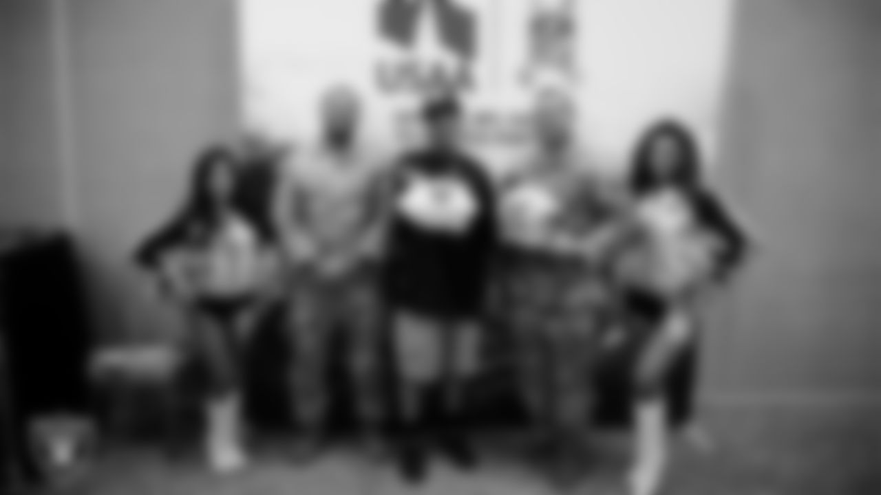 Raiderettes Tatiana and Lexie pose for a photo with service members at Nellis Air Force Base.