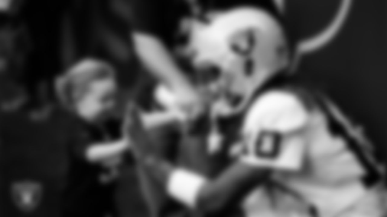 Las Vegas Raiders wide receiver Dont'e Thornton Jr. (10) with a fan before the regular season away game against the Houston Texans at NRG Stadium.