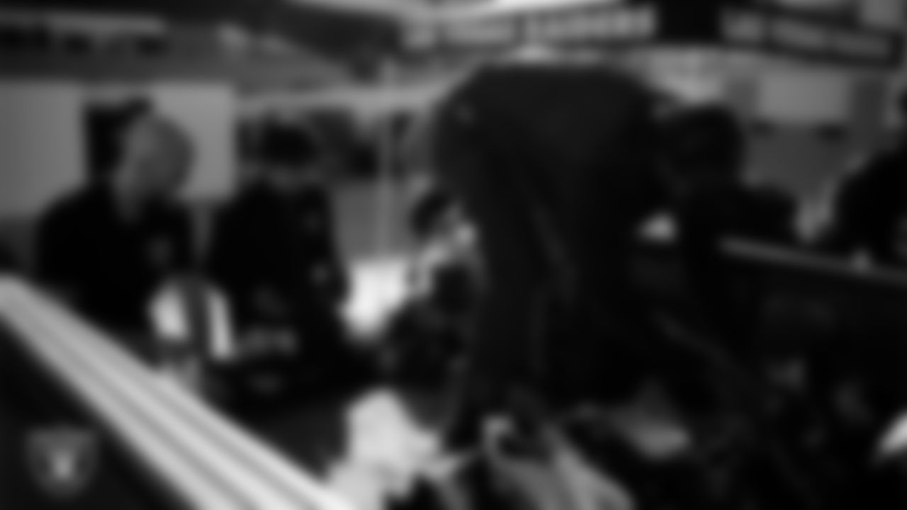 Las Vegas Raiders ambassadors load equipment into a vehicle during the Raiders' Equipment Blitz at Intermountain Health Performance Center.