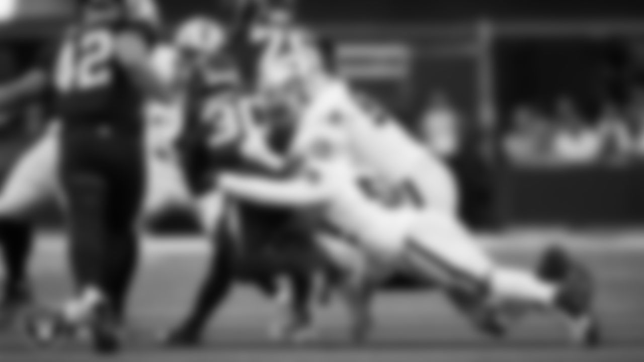 Las Vegas Raiders linebacker Elandon Roberts (52) and defensive tackle Jonah Laulu (96) make a tackle during the regular season away game against the Los Angeles Chargers at SoFi Stadium.