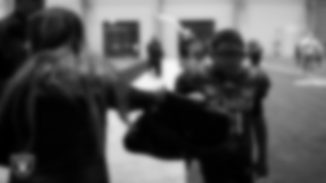 An athlete receives Las Vegas Raiders gear during an open practice at Intermountain Health Performance Center.