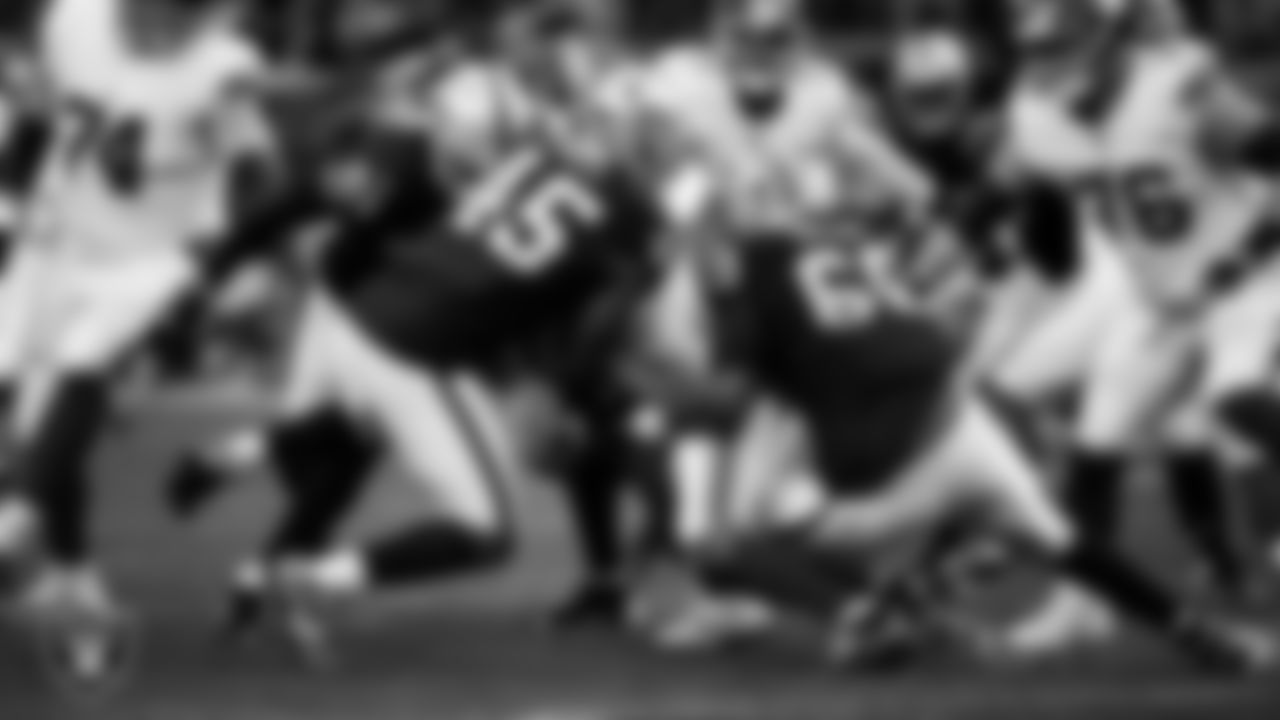 Las Vegas Raiders linebacker Devin White (45) and defensive tackle Adam Butler (69) make a tackle during the regular season home game against the New York Giants at Allegiant Stadium.