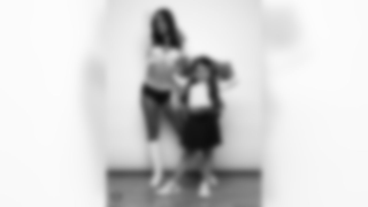 Raiderette Reagan poses for a photo with a Junior Raiderette during 2025 Media Day at The Studio.