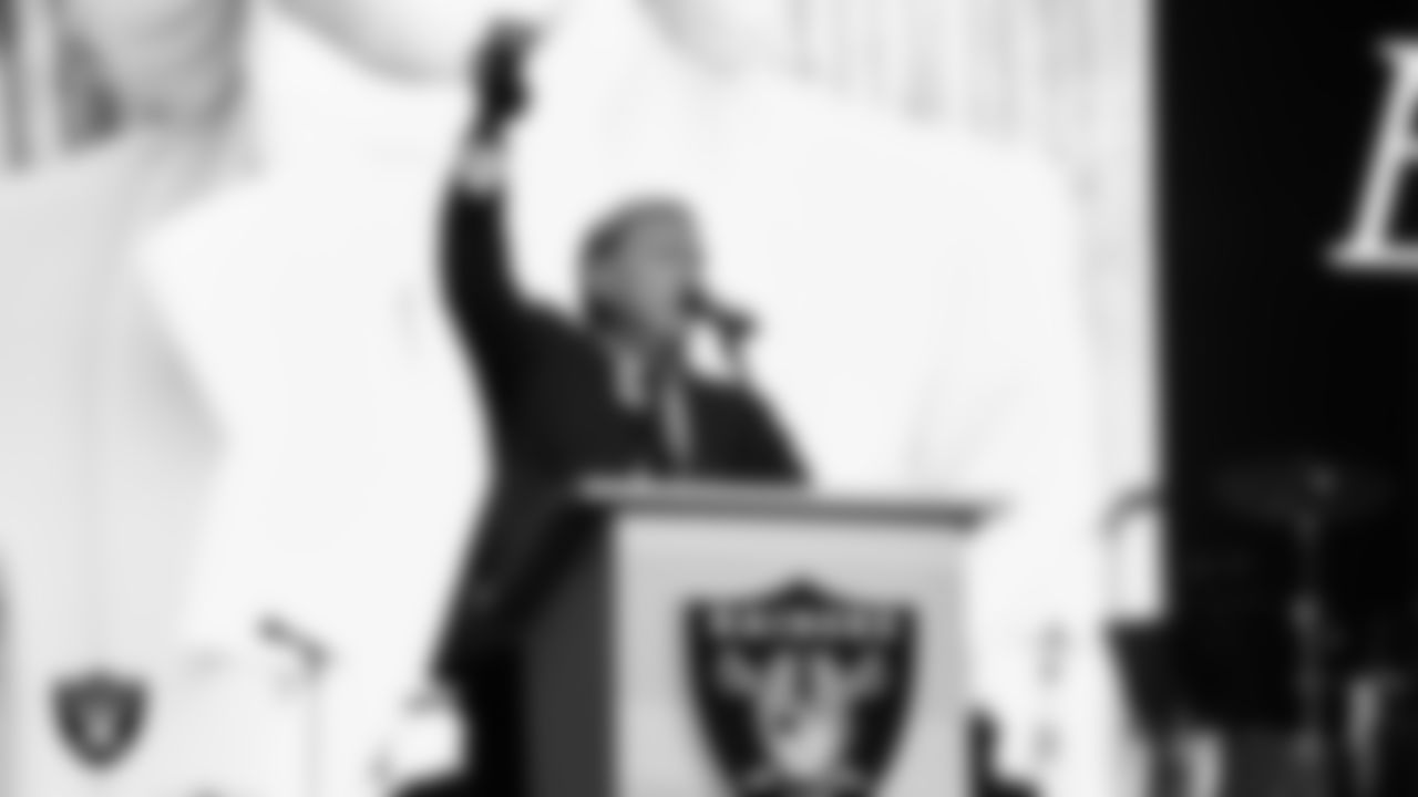 Las Vegas Raiders Owner Mark Davis lights the Al Davis Memorial Torch to honor business woman Elaine Wynn during the second annual Silver & Black Gala hosted by The Raiders Foundation at Allegiant Stadium.
