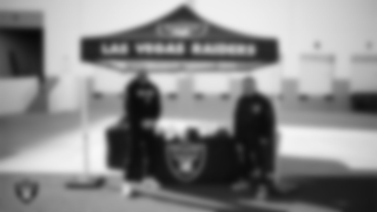 Las Vegas Raiders senior manager of football development Jordan Aguilar poses for a photo with Chaparral High School football coach Thomas Hess during the football development equipment giveaway at Las Vegas Raiders Headquarters.
