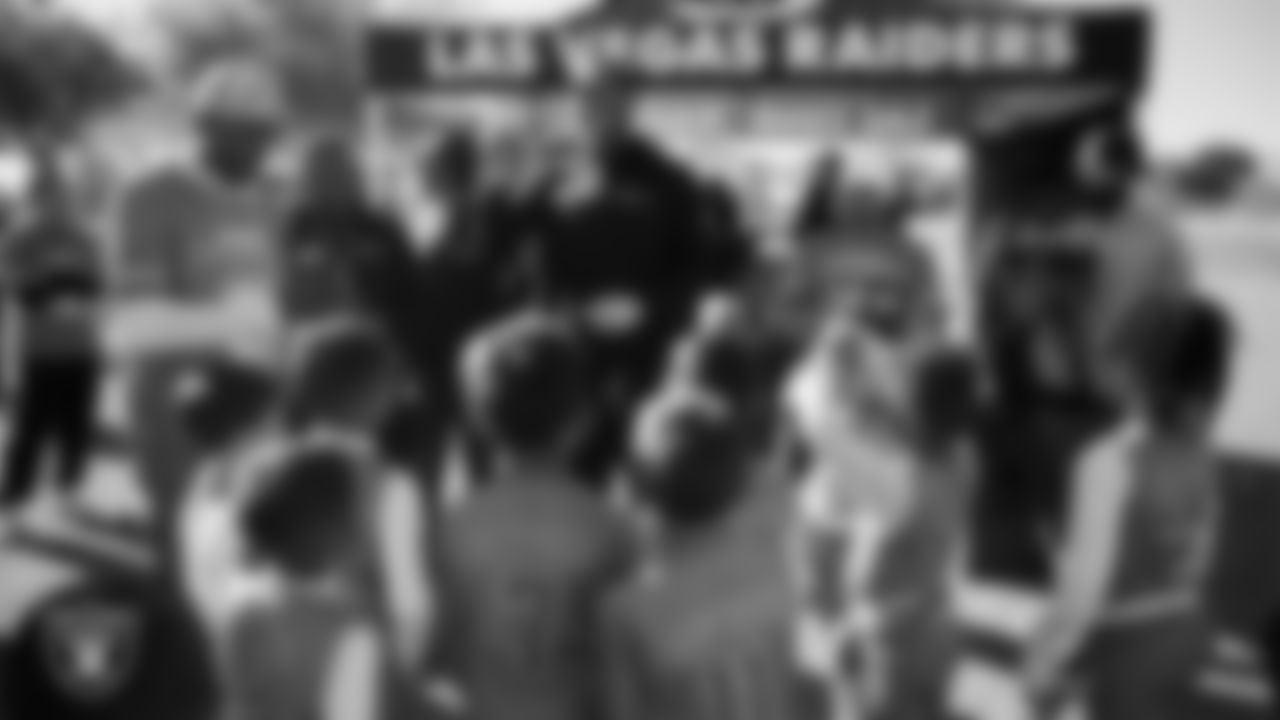 A member of the Las Vegas Metropolitan Police Department hands out championships rings to athletes during the LEEAP Flag Football Tournament at Desert Breeze Park.