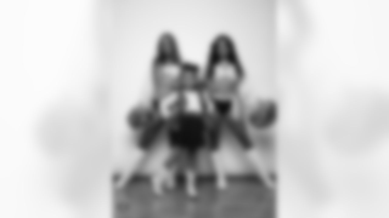 Raiderettes Madisyn and Annalise pose for a photo with a Junior Raiderette during 2025 Media Day at The Studio.