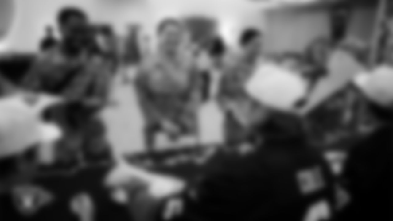 Service members get autographs from Las Vegas Raiders players at Nellis Air Force Base.