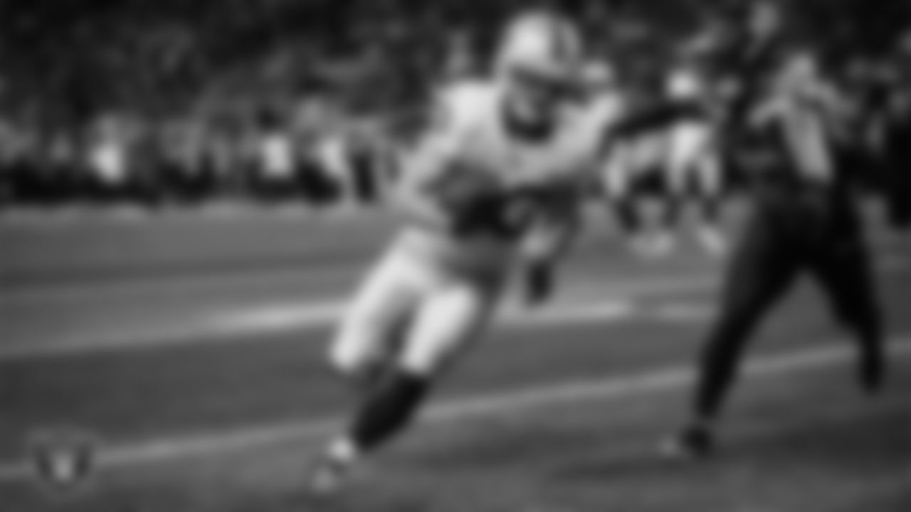 Las Vegas Raiders running back Dylan Laube (23) runs after making a 6-yard touchdown catch during the preseason away game against the Seattle Seahawks at Lumen Field.