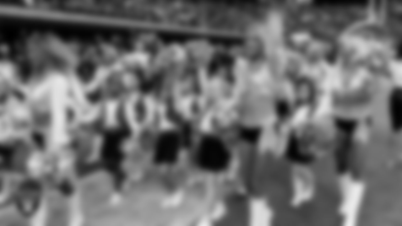 Raiderette Delaney and Junior Raiderettes exit the field after their performance before the preseason home game against the San Francisco 49ers at Allegiant Stadium.