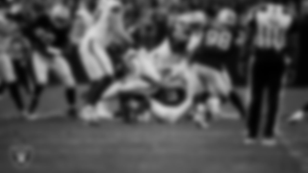 Las Vegas Raiders defensive end Charles Snowden (49) makes a tackle during the regular season home game against the Denver Broncos at Allegiant Stadium.