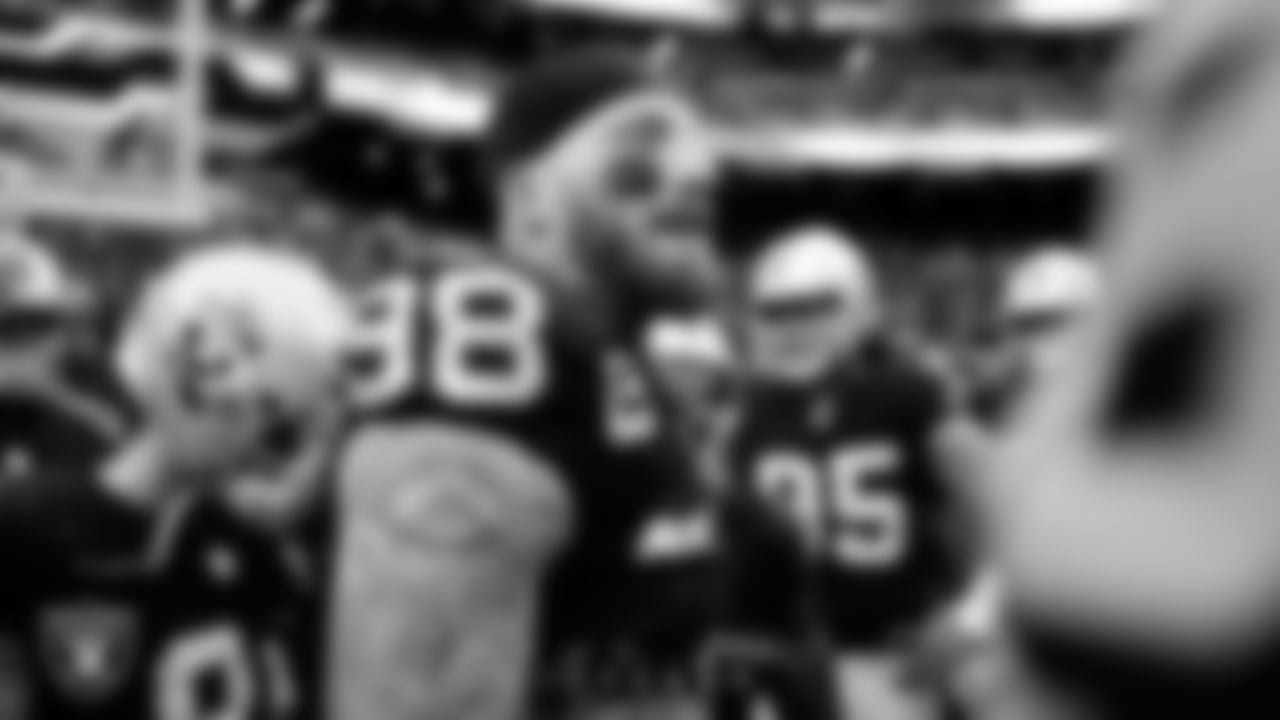 Las Vegas Raiders defensive end Maxx Crosby (98) in a huddle before the regular season home game against the Tennessee Titans at Allegiant Stadium.