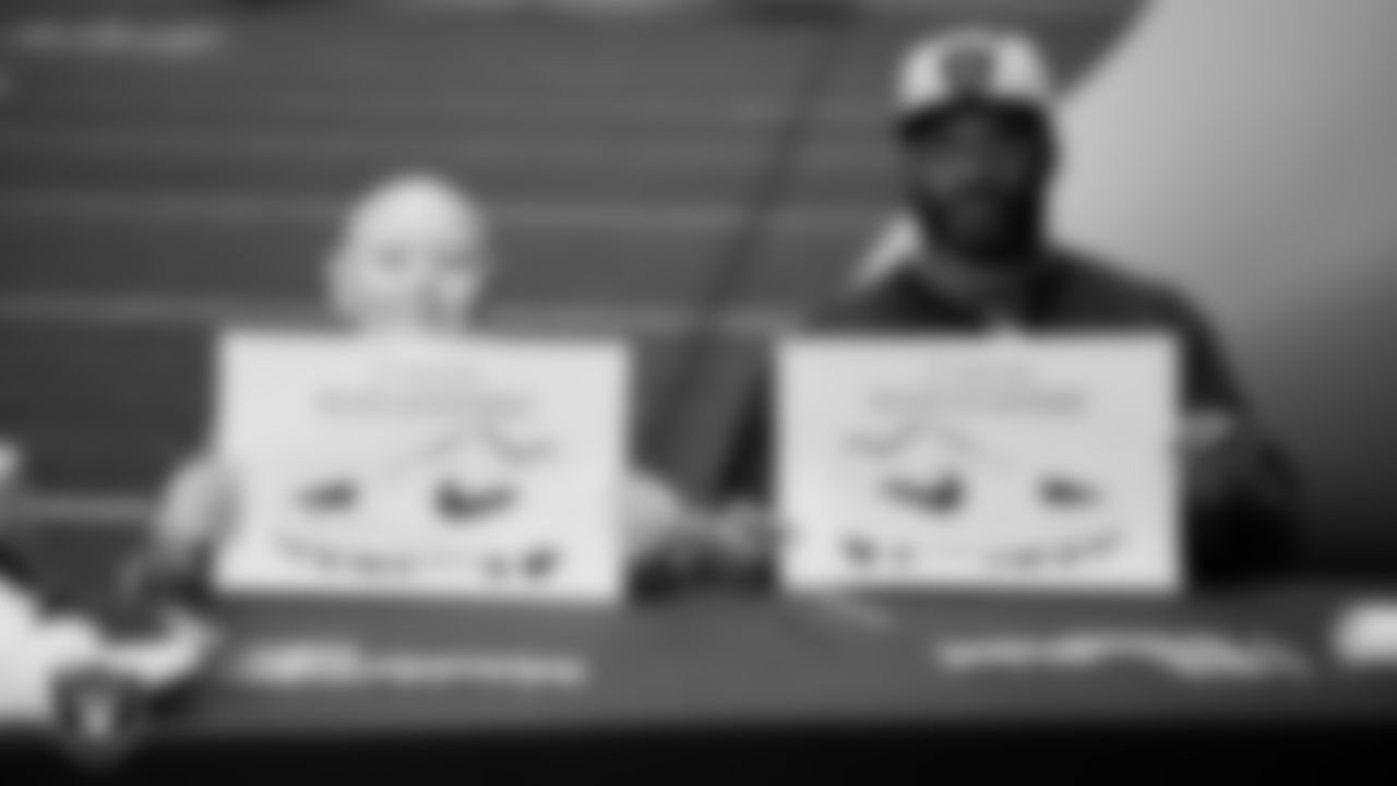 Las Vegas Raiders linebacker Elandon Roberts (52) designs cleats for My Cause My Cleats with Intermountain Children's Health patient Isaak at Intermountain Health Performance Center.