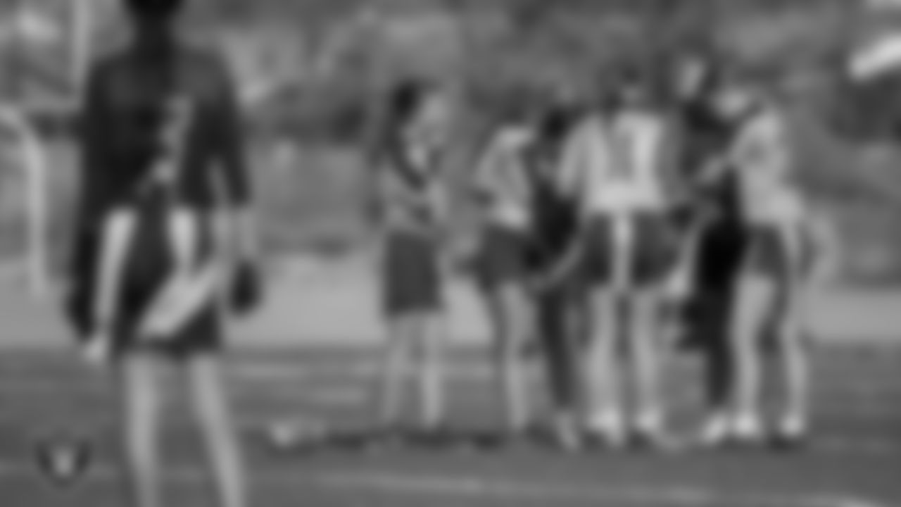 Athletes huddle during a Silver and Black Flag Football League preseason tournament at All American Park.