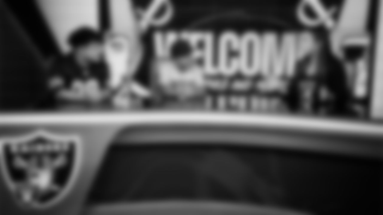 Christopher Arias and Marcos Carrillo from Make-A-Wish talk with Las Vegas Raiders manager of community relations Shelby Hurd in the Cox Studio during a visit to Intermountain Health Performance Center.