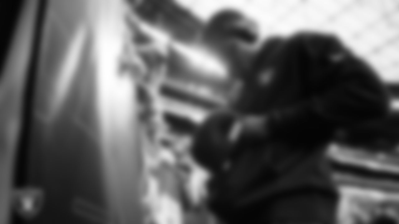 Las Vegas Raiders cornerback Jakorian Bennett (0) signs autographs for fans before the regular season home game against the New York Giants at Allegiant Stadium.