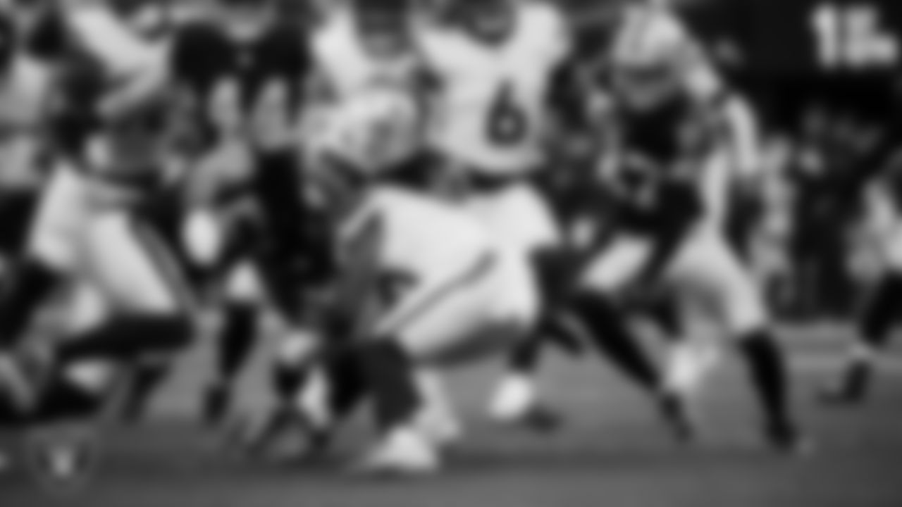 Las Vegas Raiders linebacker Jon Rhattigan (59) and running back Dylan Laube (23) make a tackle during the regular season home game against the Denver Broncos at Allegiant Stadium.