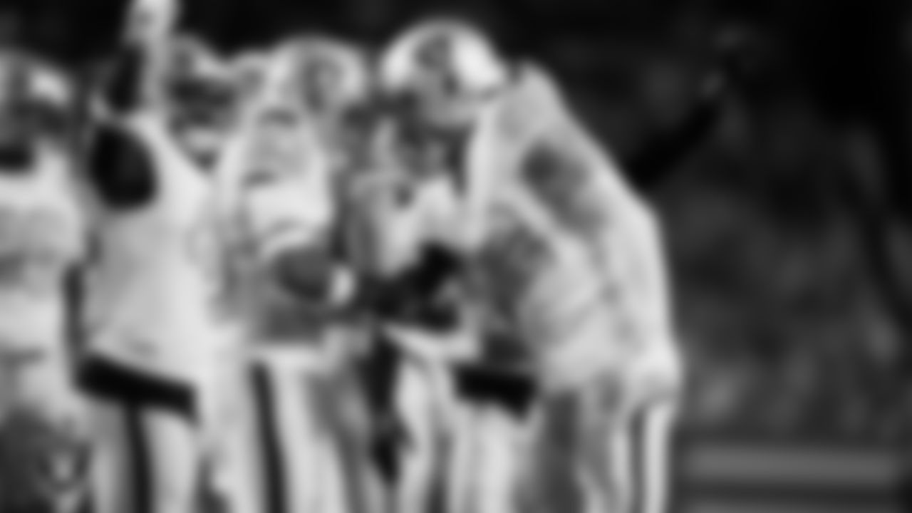 Las Vegas Raiders defensive end Maxx Crosby (98) celebrates with linebacker Jamal Adams (33) after making a tackle during the regular season away game against the Denver Broncos at Empower Field at Mile High.