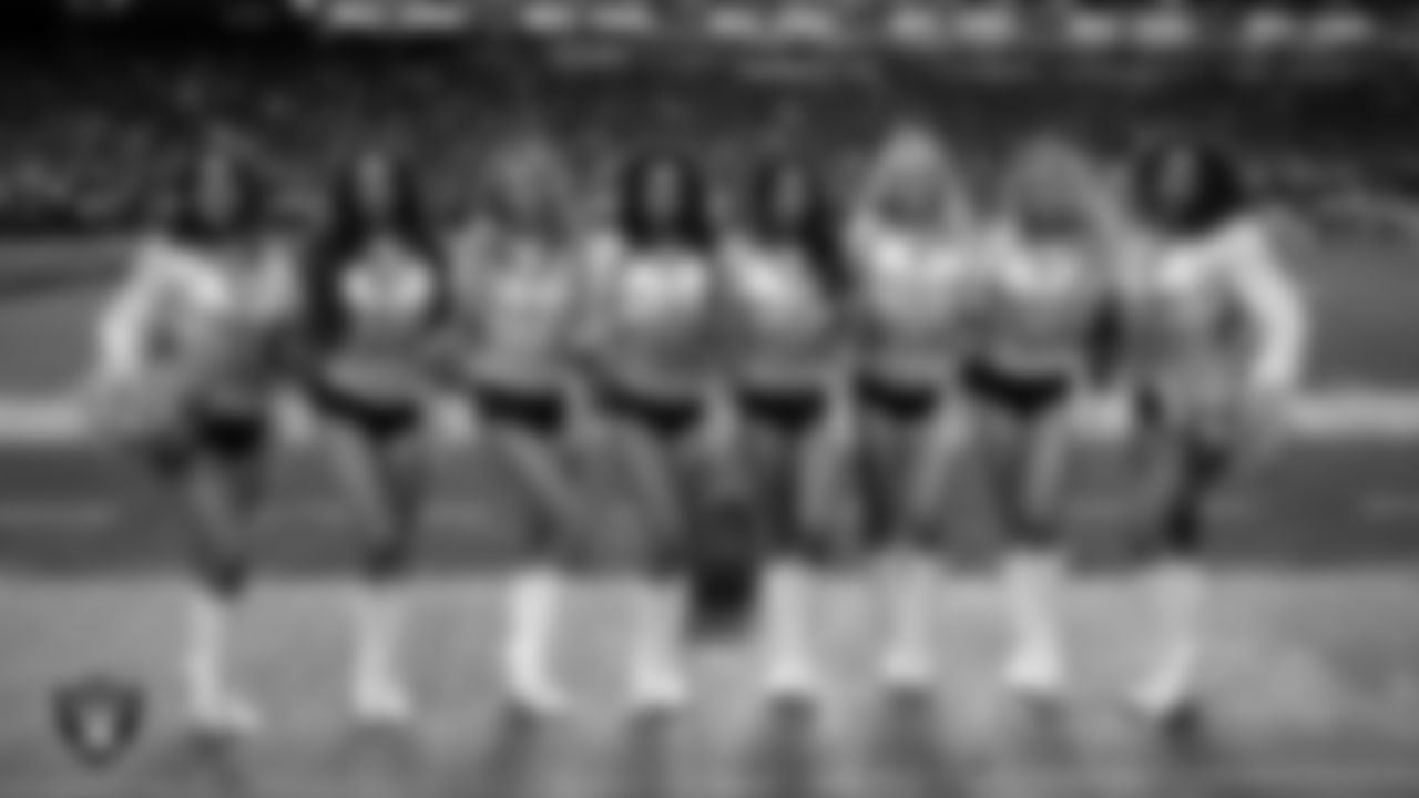 Line 3 of the Raiderettes pose for a photo on the sidelines during the regular season home game against the New York Giants at Allegiant Stadium.