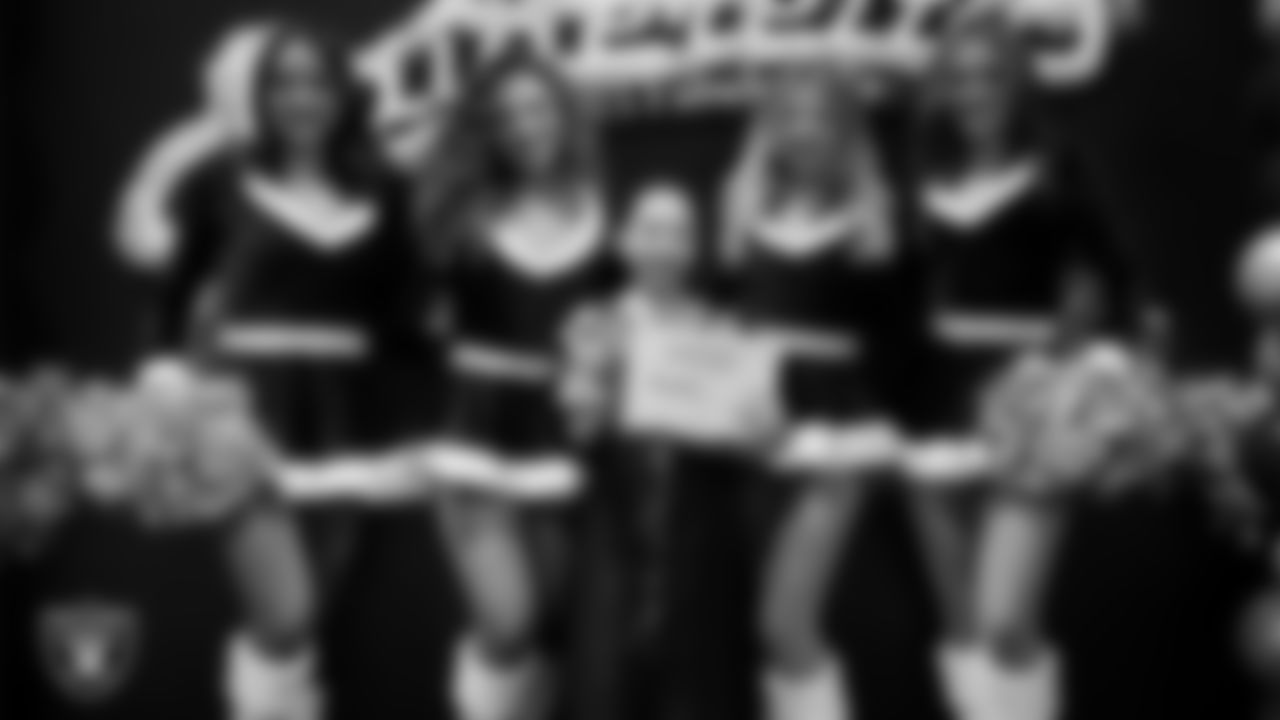 Raiderettes pose for a photo with a Junior Raiderette during the Junior Raiderettes Banquet at The Studio.