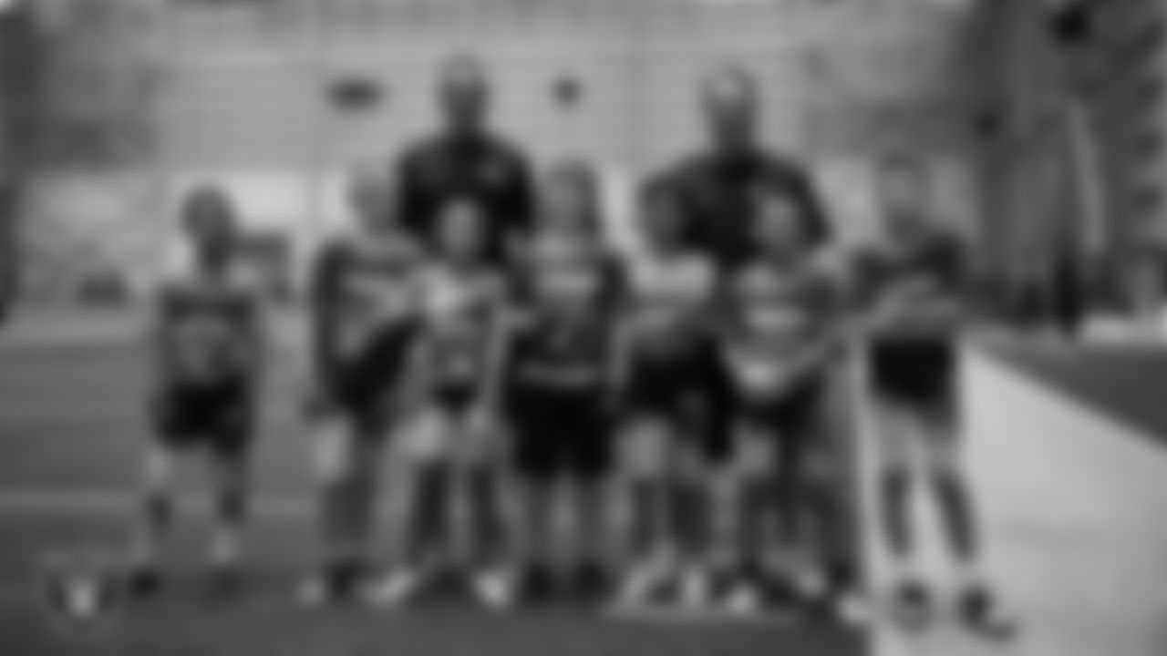 Athletes and coaches pose for a photo during practice at Intermountain Health Performance Center.