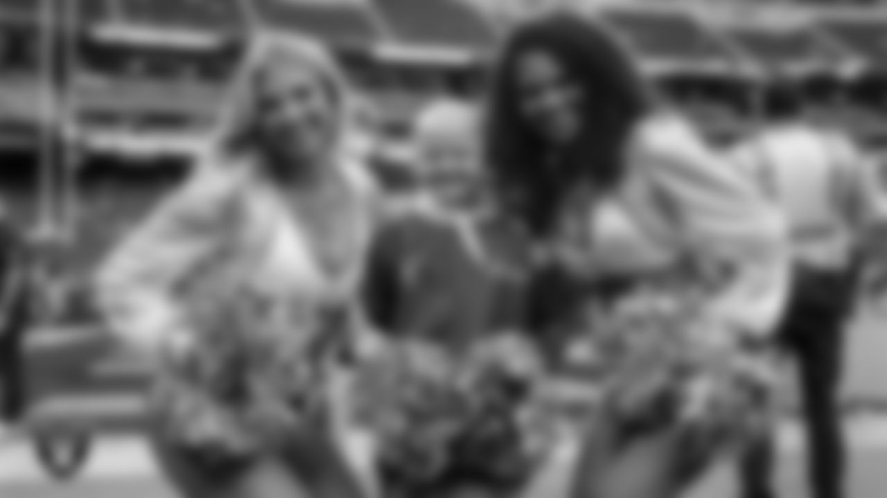 Raiderettes Cori and Shayla with Intermountain Children's Health patient Jade before the Las Vegas Raiders' regular season home game against the Tennessee Titans at Allegiant Stadium.