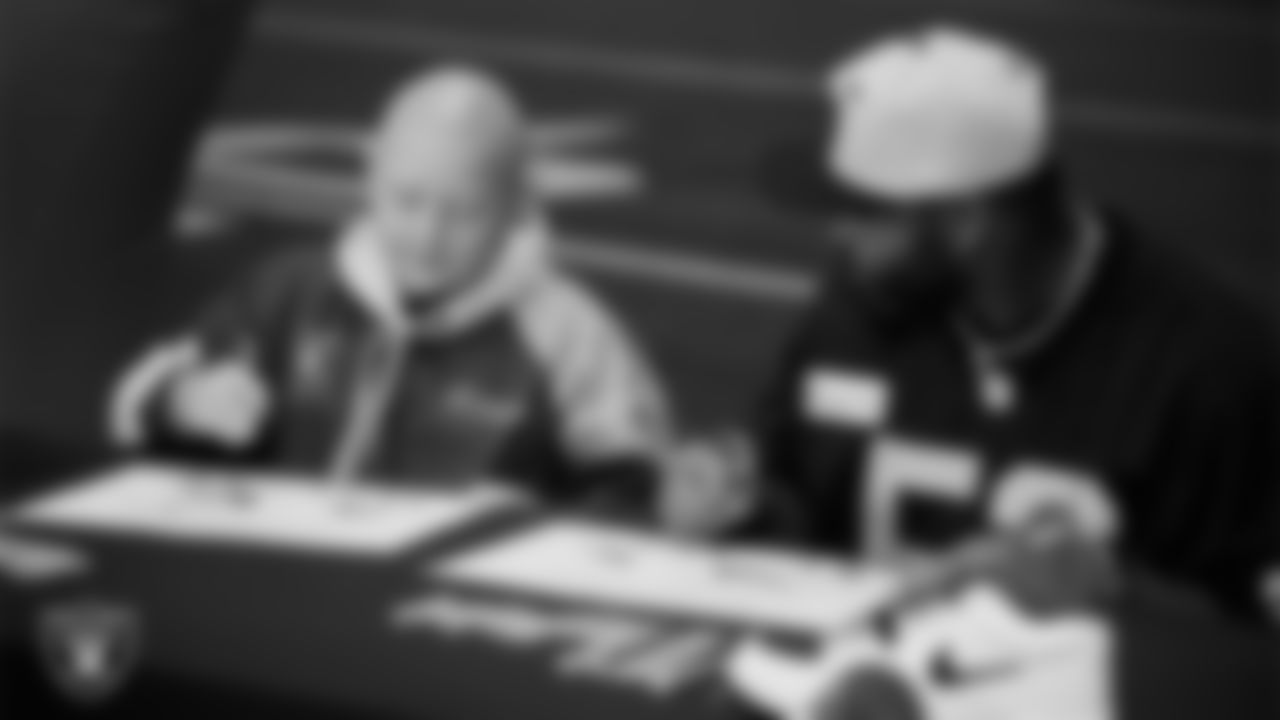 Las Vegas Raiders linebacker Elandon Roberts (52) designs cleats for My Cause My Cleats with Intermountain Children's Health patient Isaak at Intermountain Health Performance Center.