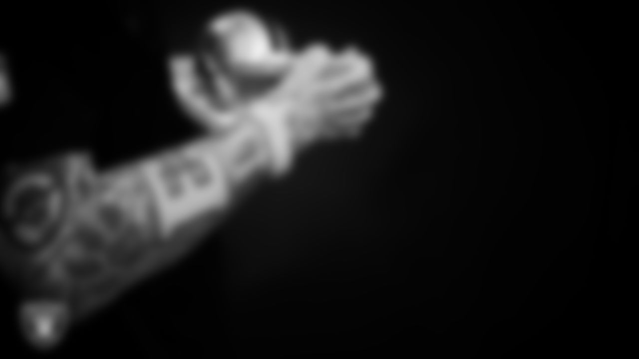 Las Vegas Raiders defensive end Maxx Crosby (98) signs autographs for fans before the regular season home game against the Kansas City Chiefs at Allegiant Stadium.