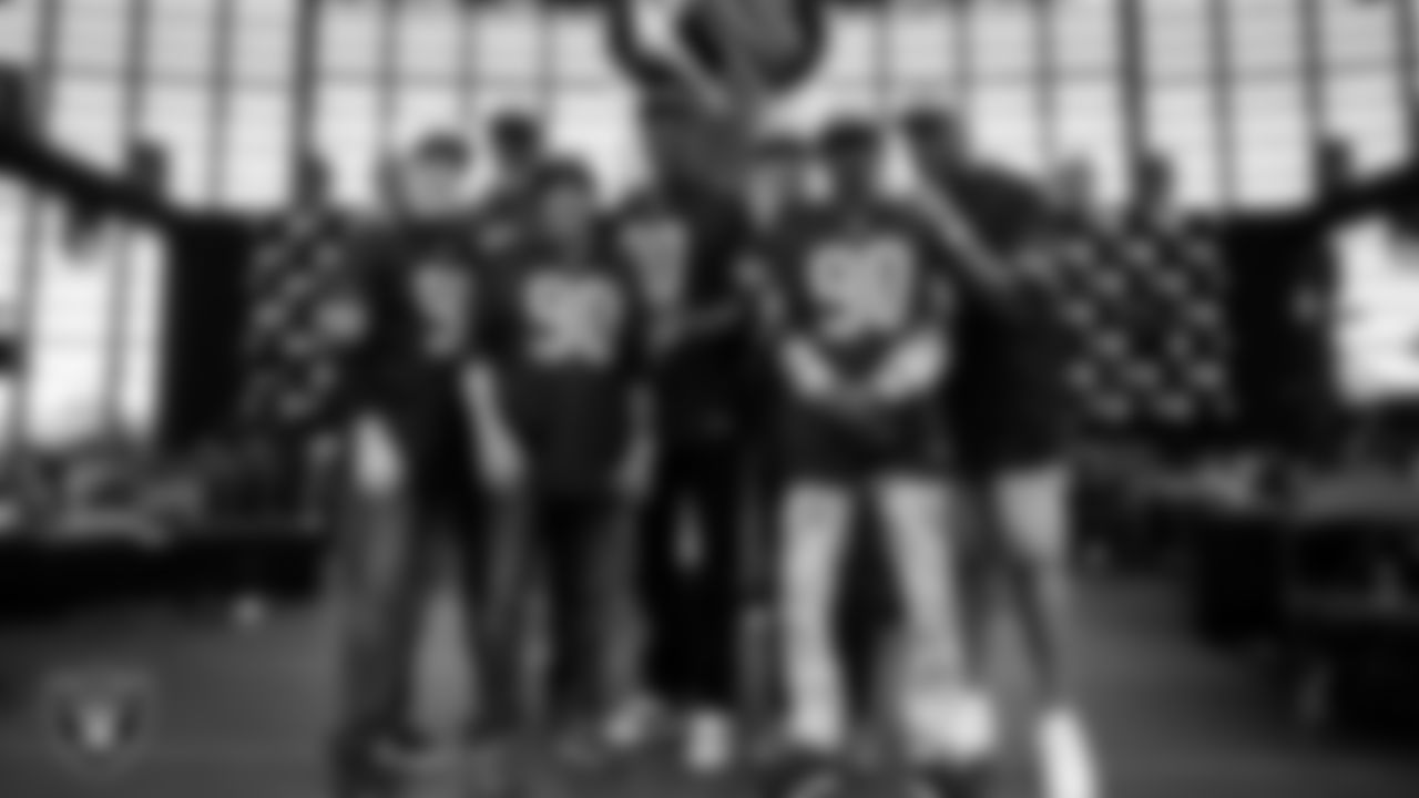 The 1990 UNLV Runnin' Rebels National Championship Team lights the Al Davis Memorial Torch before the Las Vegas Raiders' regular season home game against the Jacksonville Jaguars at Allegiant Stadium.