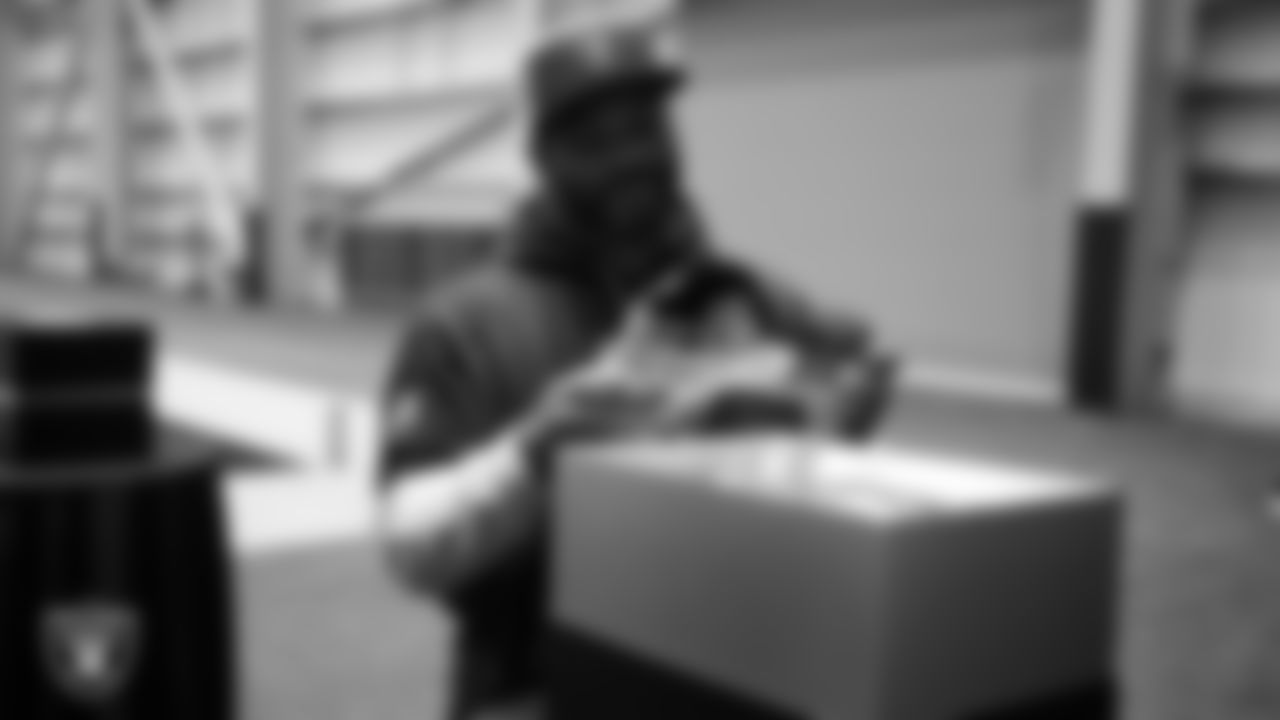 Las Vegas Raiders linebacker Elandon Roberts (52) unboxes his custom cleats for the NFL's My Cause My Cleats initiative at Intermountain Health Performance Center.