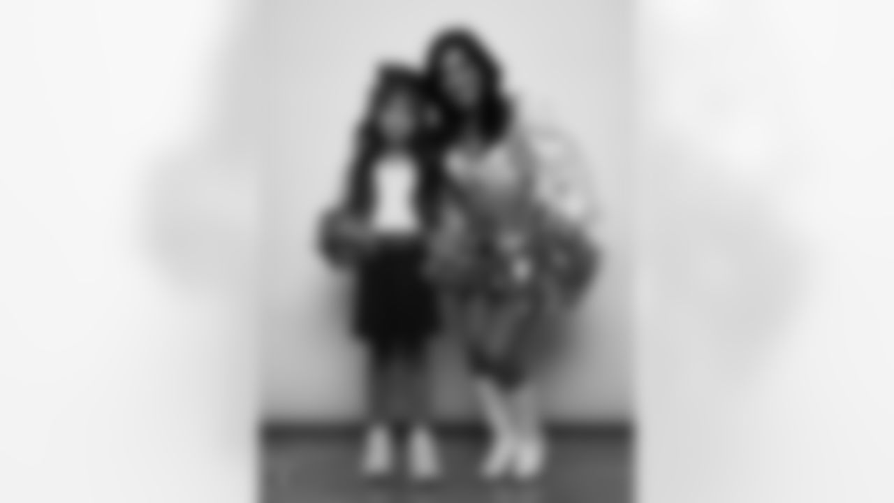 Raiderette Tatiana poses for a photo with a Junior Raiderette during 2025 Media Day at The Studio.