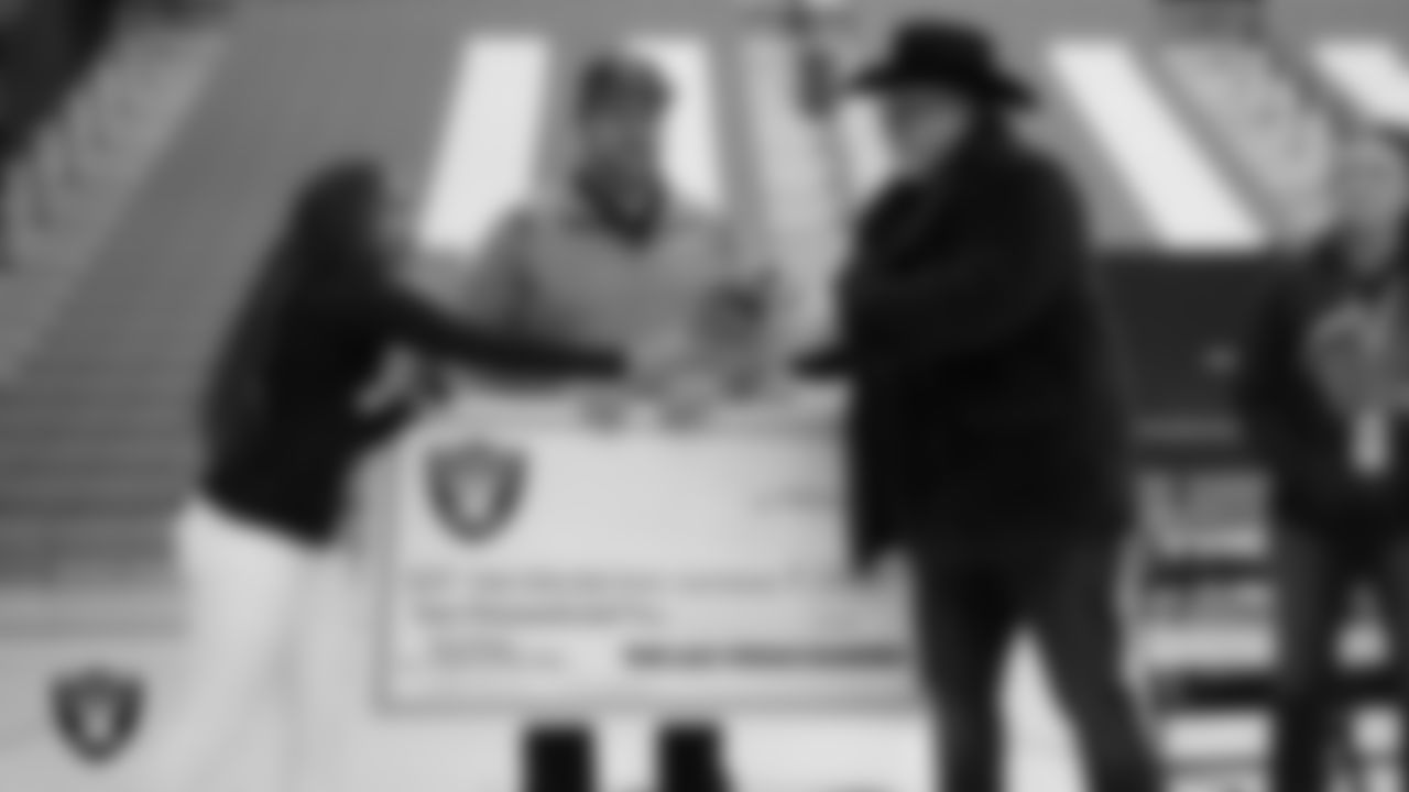 Las Vegas Raiders manager of football development Marli Bartlett presents Virgin Valley High School flag football coach Joey Bowler with the Tom Flores High School Coach of the Year award at Virgin Valley High School.