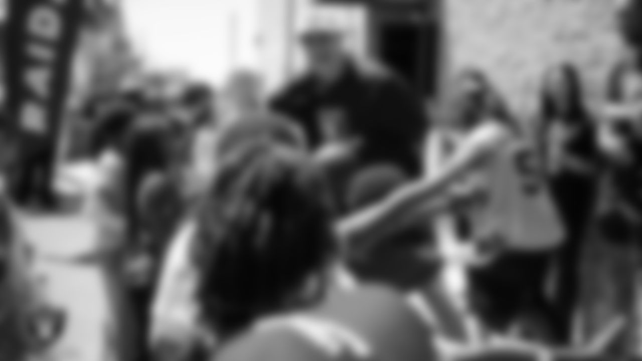 Las Vegas Raiders quarterback Aidan O'Connell (12) high-fives attendees while being introduced during the Raiders 4th annual Back-To-School Free Haircuts and Beautician Services event at Expertise Cosmetology Barber School.