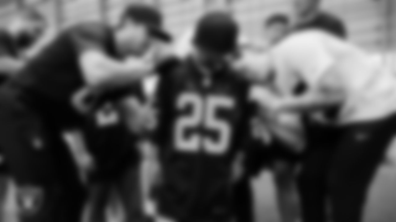 Christopher Arias from Make-A-Wish get his jersey signed after practice during a visit to Intermountain Health Performance Center.