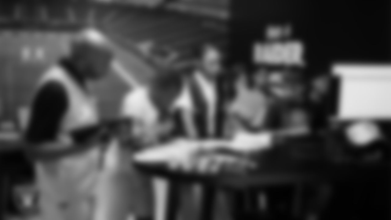 Las Vegas Raiders senior vice president and chief financial officer Michael Crome works with students during a Raiders work simulation at Betty's Junior Achievement BizTown.