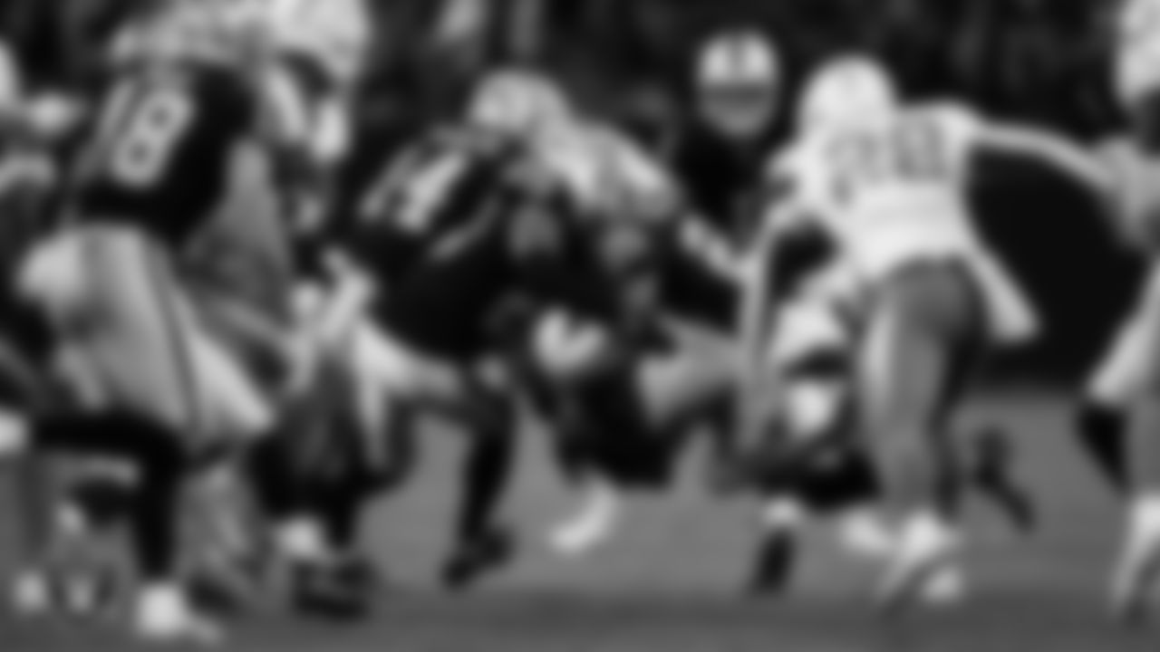 Las Vegas Raiders safety Chris Smith II (29) and cornerback Decamerion Richardson (25) make a tackle during the regular season home game against the Los Angeles Chargers at Allegiant Stadium.