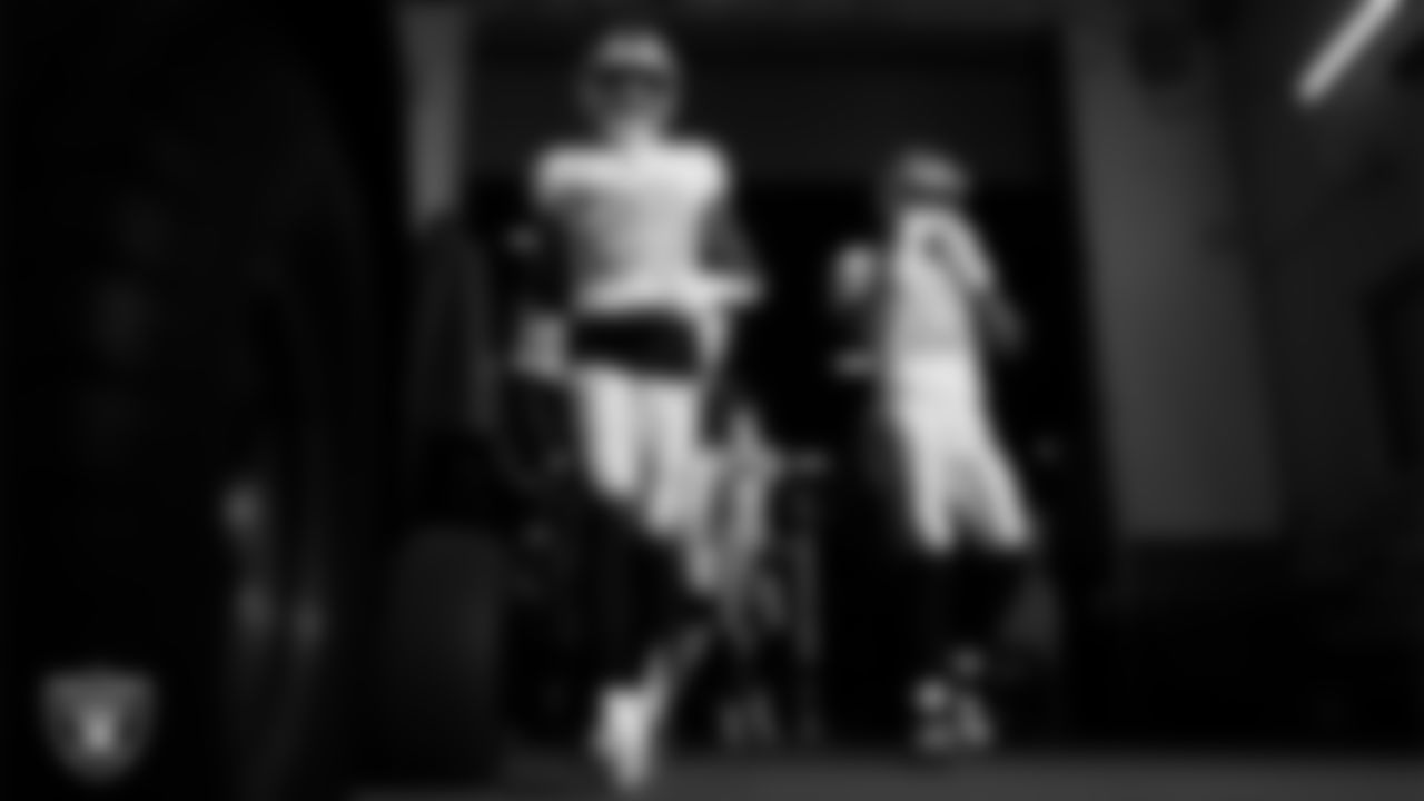 Las Vegas Raiders safety Isaiah Pola-Mao (20) and safety Jeremy Chinn (11) walk down the tunnel before the regular season away game against the Denver Broncos at Empower Field at Mile High.