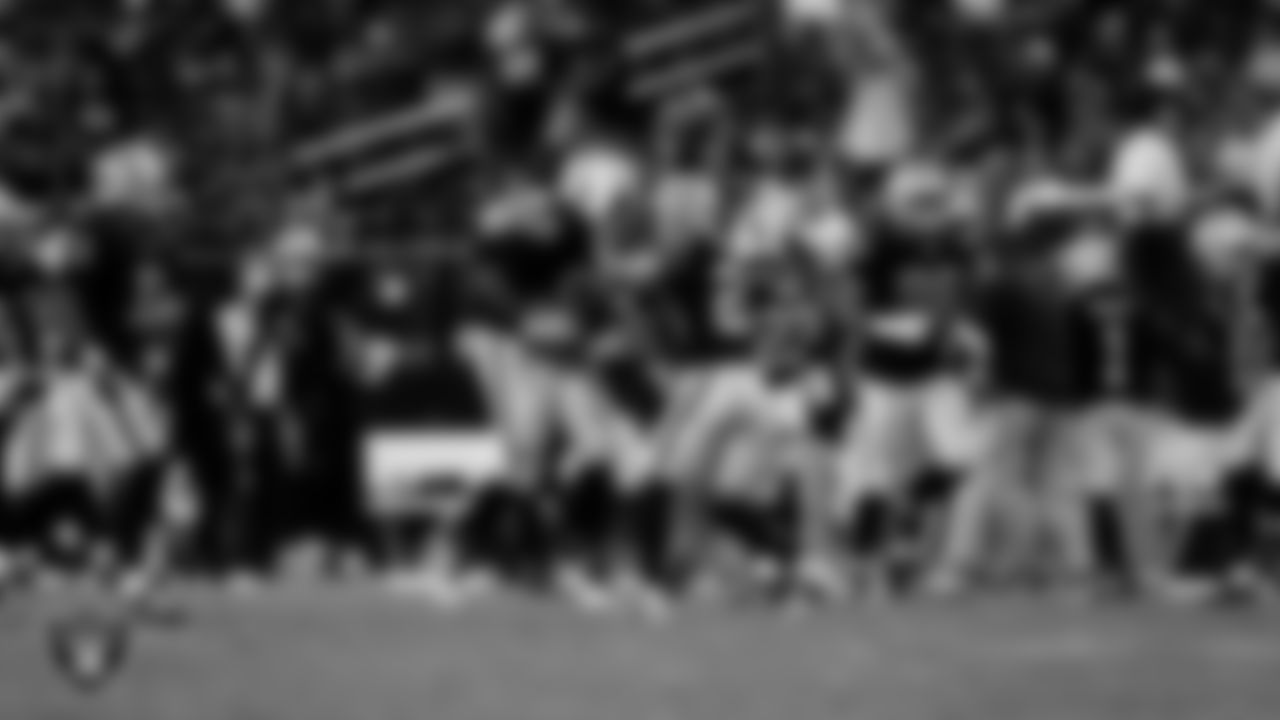 Las Vegas Raiders defensive tackle Adam Butler (69) celebrates with safety Isaiah Pola-Mao (20) after recovering a fumble during the regular season home game against the Los Angeles Chargers at Allegiant Stadium.