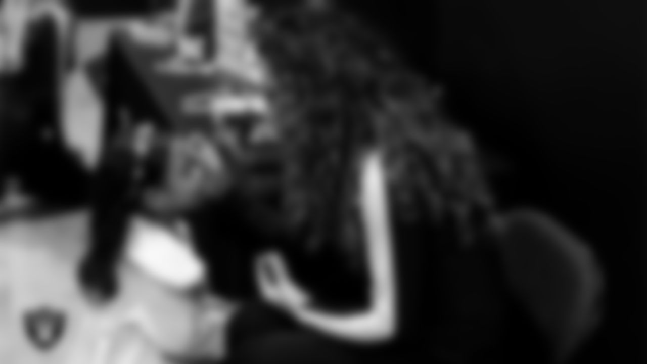 Raiderette Lexie does an attendee's makeup during the Valentine's Day Dance at The Studio.