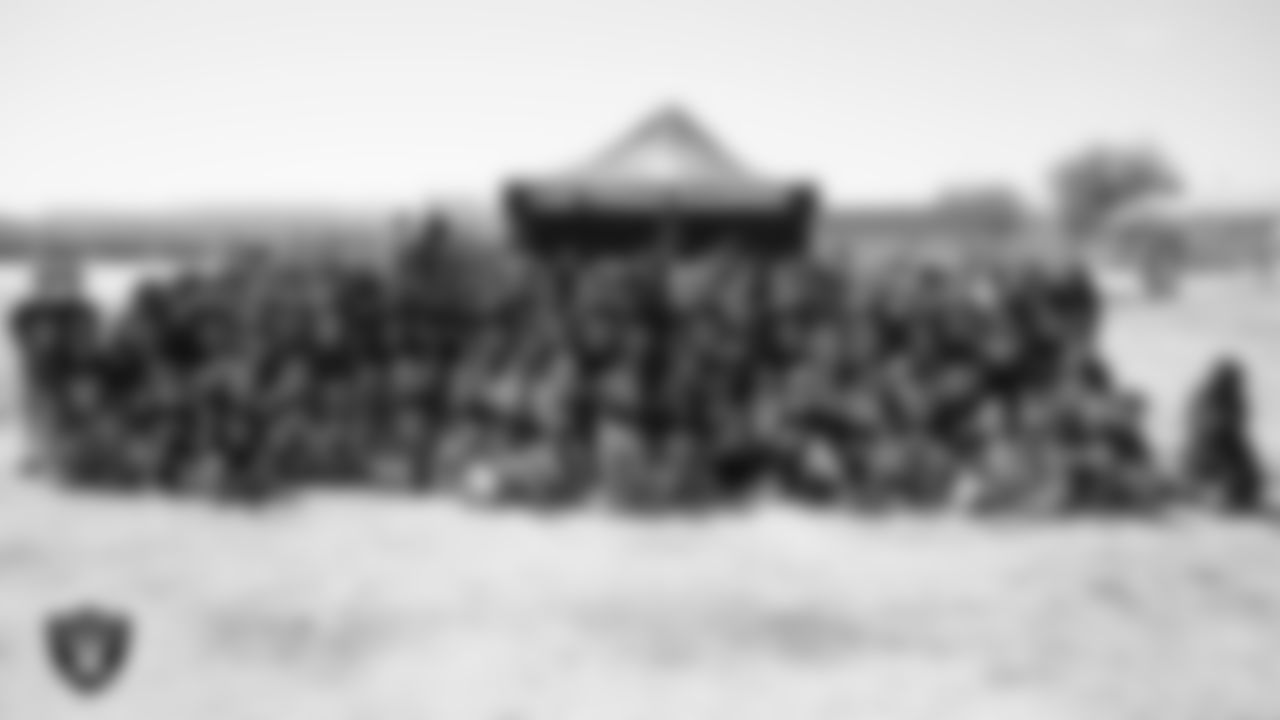 Raider Rusher and students pose for a photo during a Raiders Junior Training Camp at Steve Schorr Elementary School.