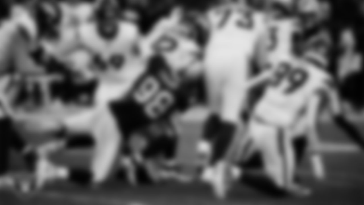 Las Vegas Raiders defensive end Maxx Crosby (98) makes a tackle during the regular season home game against the Denver Broncos at Allegiant Stadium.