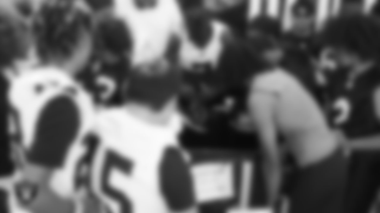 Members of the Clark High School football team look over donated equipment before a spring football practice at Clark High School.