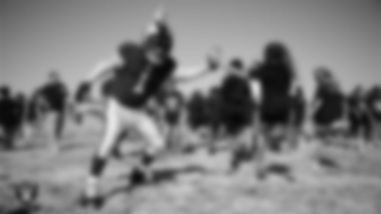 Raider Rusher high fives a student during a Raiders Junior Training Camp at Steve Schorr Elementary School.