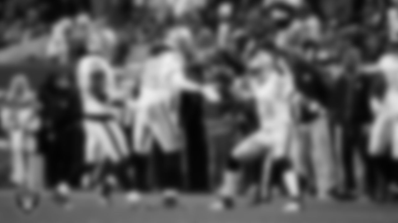 Las Vegas Raiders safety Lonnie Johnson Jr. (32) celebrates with linebacker Jamal Adams (33) after making a tackle during the regular season away game against the Denver Broncos at Empower Field at Mile High.