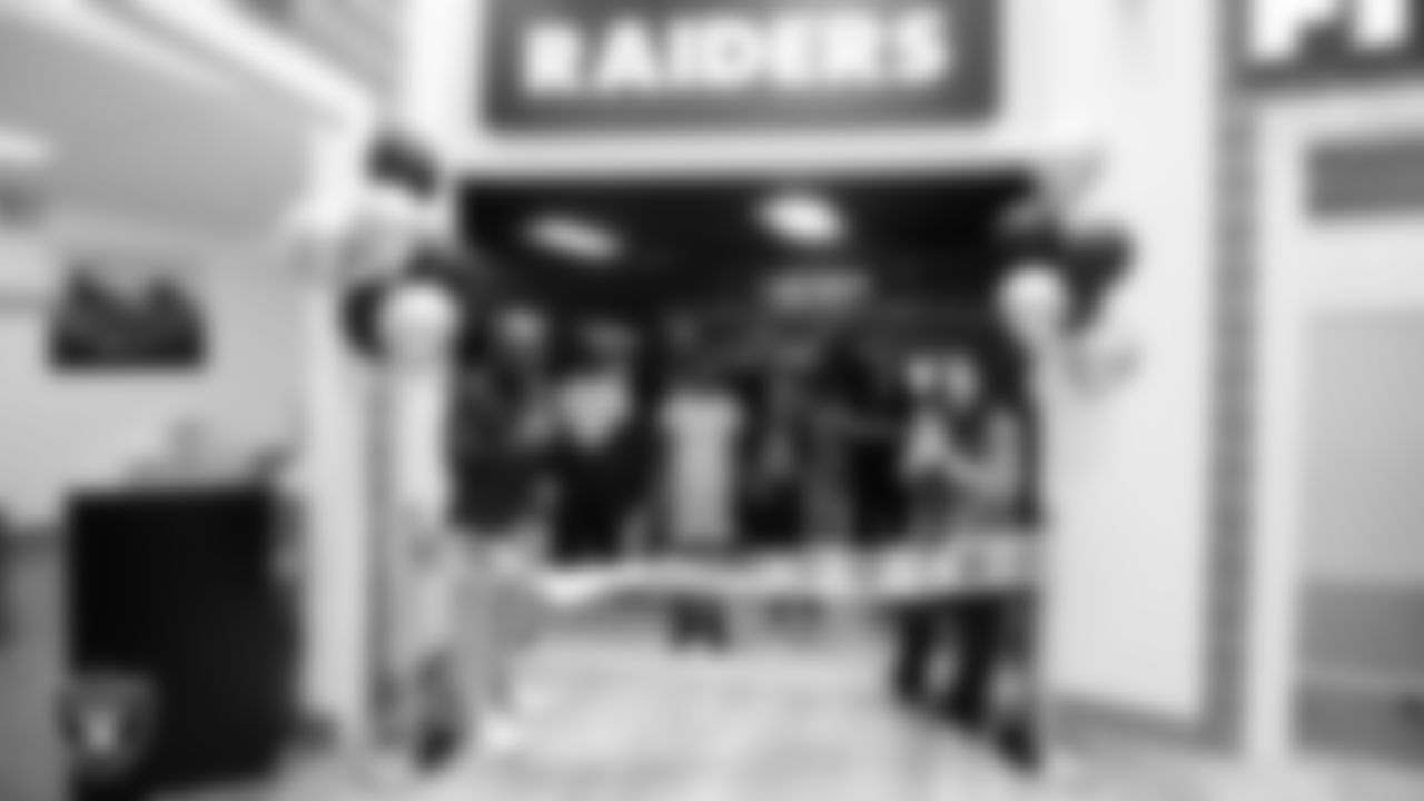 Las Vegas Raiders senior vice president and chief financial officer Michael Crome and executive director of the Raiders Foundation Kari Uyehara during a ribbon cutting at Betty's Junior Achievement BizTown.