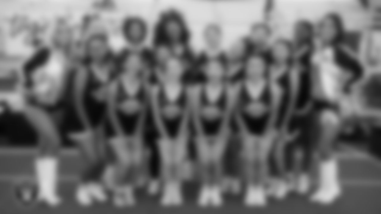 Raiderettes Pip and Reagan pose for a photo with the Clark High School cheerleaders before the Las Vegas Raiders' Football Showcase game at Clark High School.
