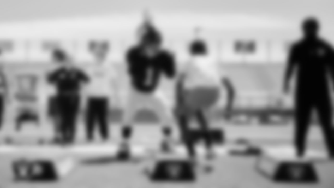 Raider Rusher helps direct an athlete through a drill during a youth football combine at Durango High School.